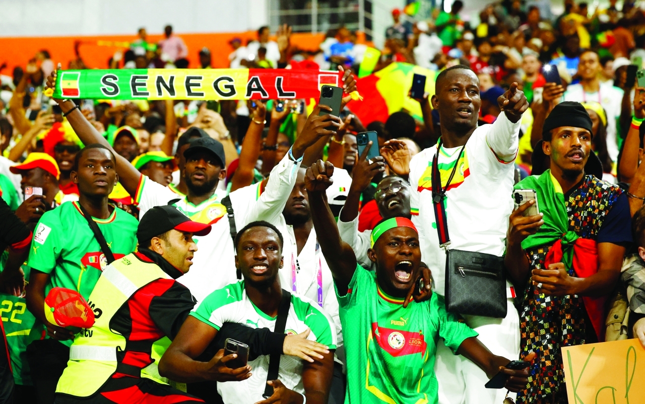 "Soccer Football - FIFA World Cup Qatar 2022 - Group A - Ecuador v Senegal - Khalifa International Stadium, Doha, Qatar - November 29, 2022  Senegal fans celebrate qualifying for the knockout stages REUTERS/Stephane Mahe"