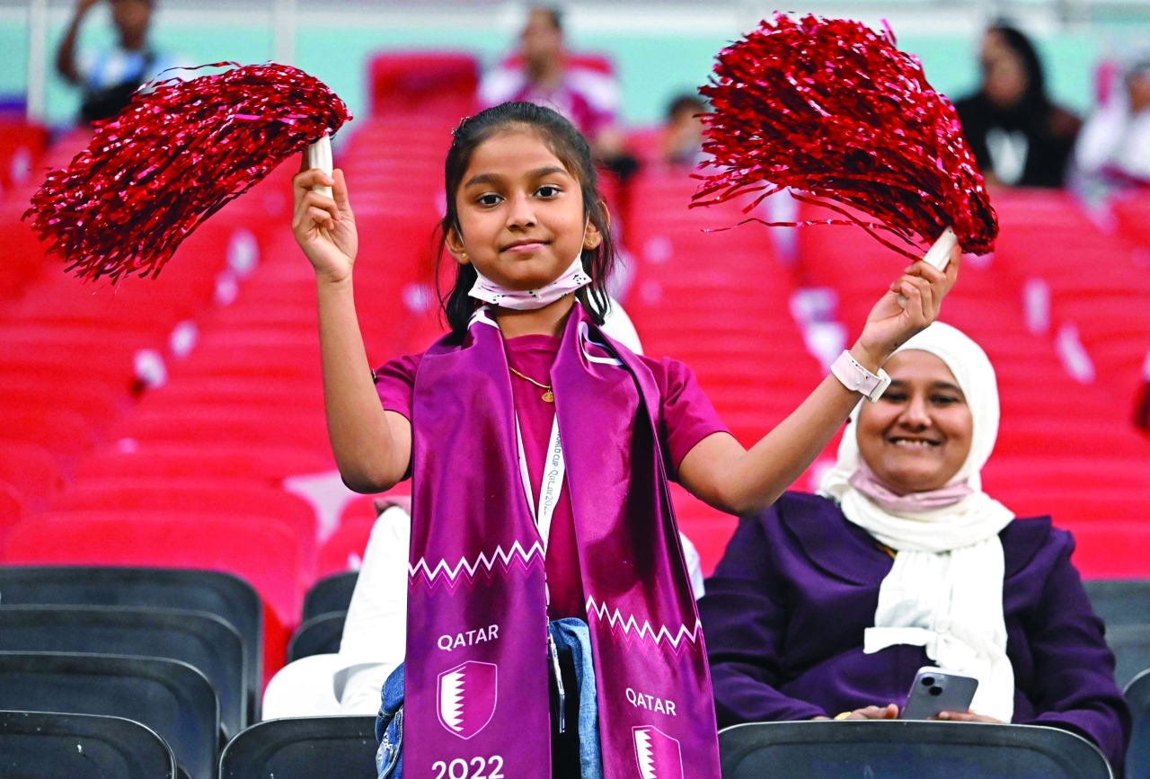 "A young Qatar fan attends the Qatar 2022 World Cup Group A football match between the Netherlands and Qatar at the Al-Bayt Stadium in Al Khor, north of Doha on November 29, 2022. (Photo by Alberto PIZZOLI / AFP)"