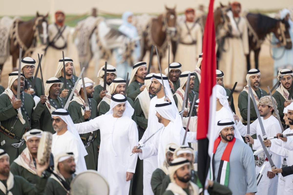 AL WATHBA, ABU DHABI, UNITED ARAB EMIRATES - December 07, 2024: HH Sheikh Hamed bin Zayed Al Nahyan (L), HH Sheikh Omar bin Zayed Al Nahyan, Deputy Chairman of the Board of Trustees of Zayed bin Sultan Al Nahyan Charitable and Humanitarian Foundation (2nd L) and HE Sheikh Shakhbut bin Nahyan bin Mubarak Al Nahyan, UAE Minister of State (3rd L), participate in a traditional dance during the March of the Union, at the Sheikh Zayed Heritage Festival.

( Abdulla Al Bedwawi /  UAE Presidential Court )
---